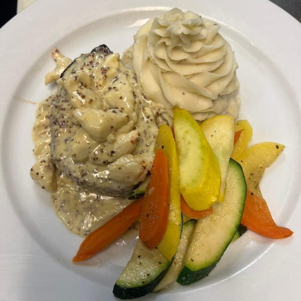 Monalisia's Italian dish with creamy sauce, mashed potatoes, and roasted zucchini and carrots.