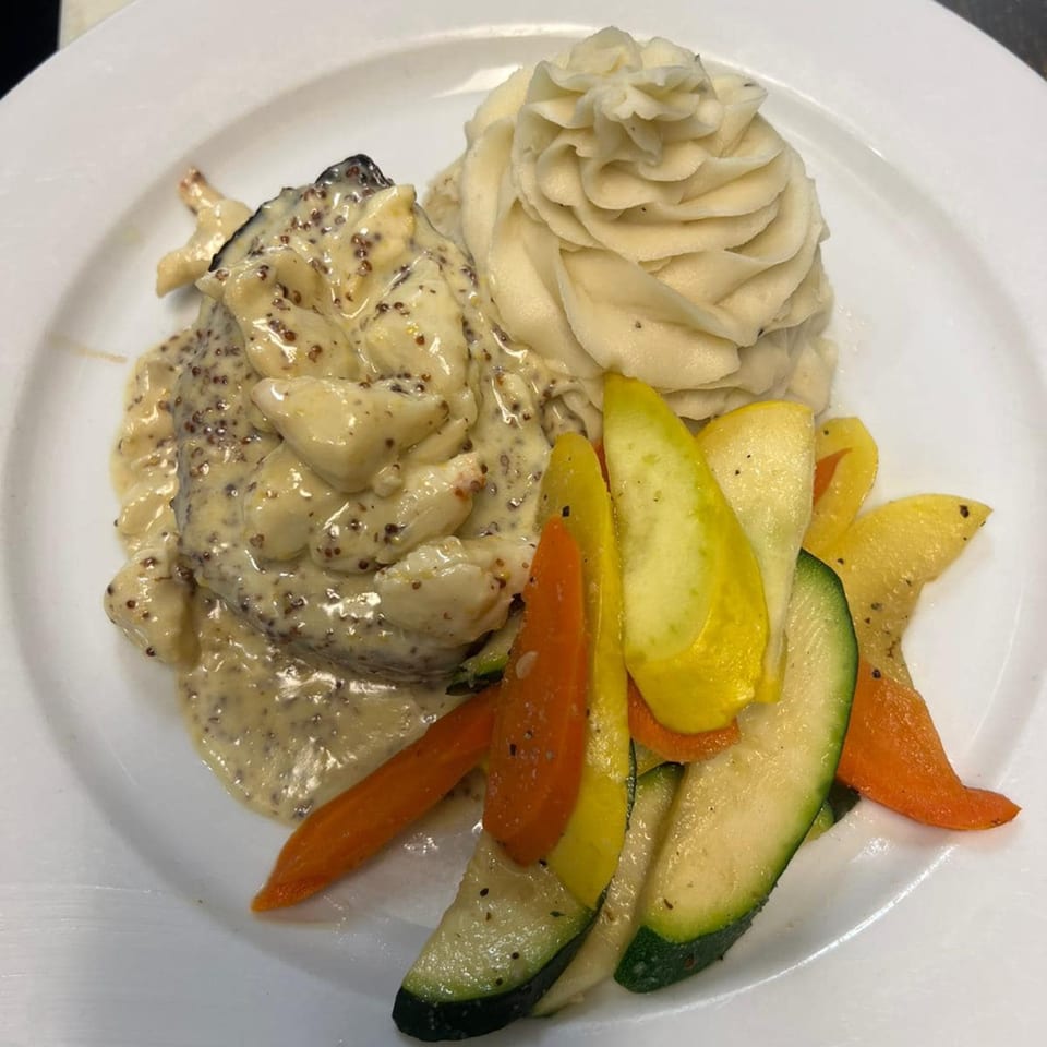 Monalisia's Italian dish with creamy sauce, mashed potatoes, and roasted zucchini and carrots.