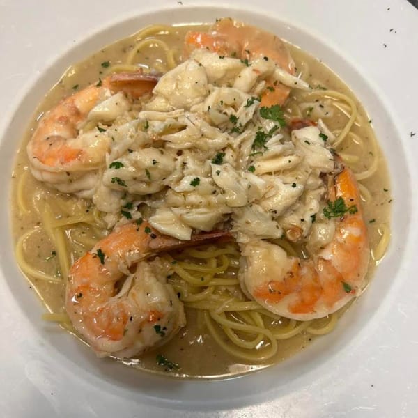 Monalisia's Italian seafood pasta with shrimp, crab meat, and parsley in a white wine sauce.