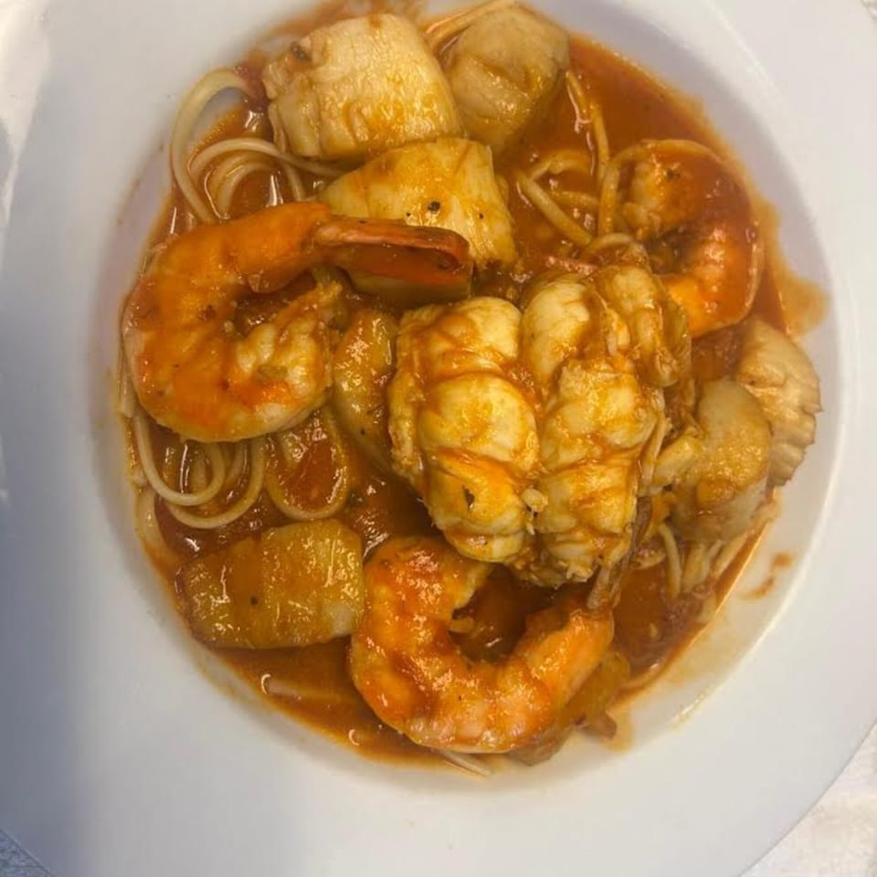 Monalisia's seafood pasta with shrimp, scallops, and lobster in a rich red sauce.